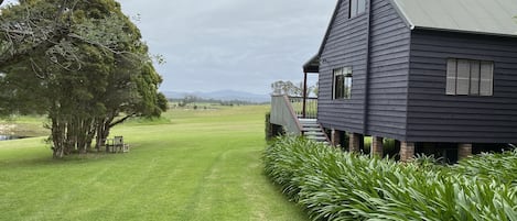 The Cottage has stunning views across grazing land to the Great Dividing Range