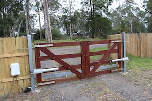 electronic entry gates (also a metal farm gate beside it)
