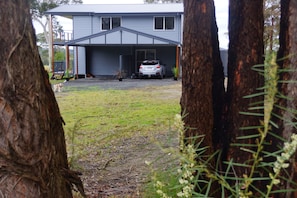 View from entry gate, 2-storey private residence and guest carports