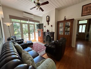 Loungeroom with Chesterfield Lounge Suite, Woodfire and Split System.