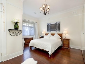 Luxury King bed in Master Bedroom with Beautiful Stained Glass French Doors. 