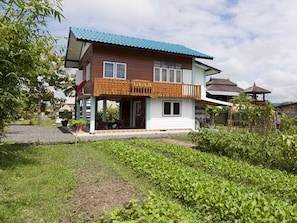Teakwood house seen from the organic vegetable garden