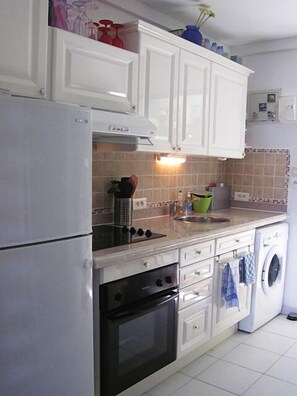 A fully equipped kitchen for preparing your meal and a washing machine