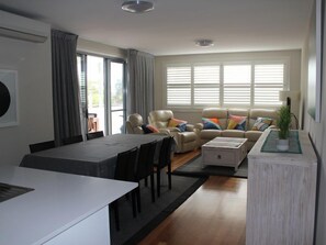 Lounge and dining area opening onto balcony.