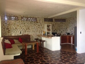 The living room is bright and airy. Open plan with kitchen and sitting area
