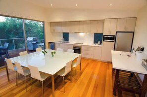 Open upstairs dining and kitchen area, leading onto large deck