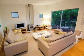 Comfortable open living area with wood burner for the winter months.