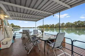 Spacious undercover rear deck with hooded bbq and swim deck