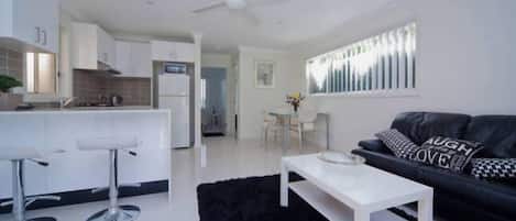 Spacious lounge and dining area with full kitchen.  Aircon and ceiling fans