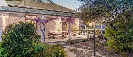 Wisteria draped wrap around verandah of Sweet Briar in the Vines Cottage