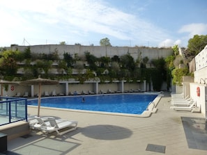 large swimming pool with two jacuzzis