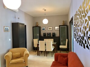 Living Room / Dining Area. The door on the right leads to the Master Bedroom.