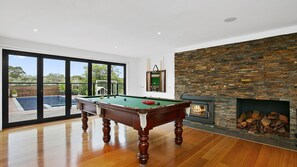 Second living space with a full sized billiard table and smart TV