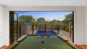 Full sized billiard table opening out to solar heated pool