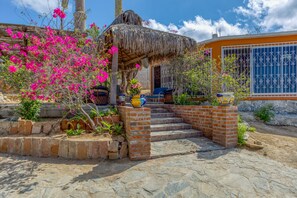 Entrance to the terrace adjacent to the house. Palapa roof & great views.