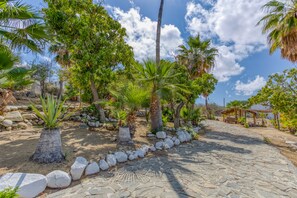 Entrance to the house made of natural stone and surrounded by nature.