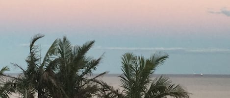 Moon rising over ocean.