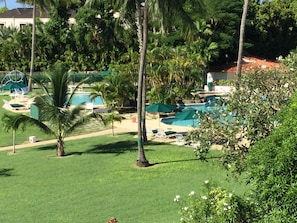 View from balcony towards pool:  adults on the right, child wading pool on left