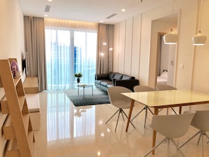 Living room with smart TV & dining area.