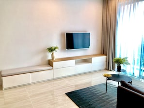 Living room with smart TV & dining area.