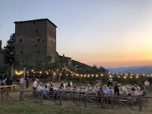 Sunset dinner lawn. Amazing view of the valley, the castle and the Tuscan sunset