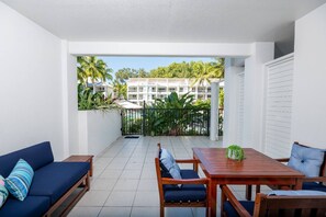 Experience pool and tropical views from the balcony, perfect for relaxation and unwinding.