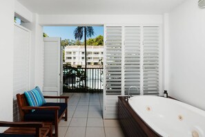 Immerse yourself in a tropical paradise as you relax in the ensuite tub with outdoor access and pool views.