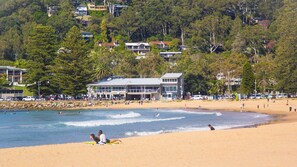 Stroll to flagged swimming area and surf club.