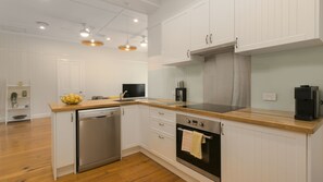 Great modern kitchen that looks into the living room area.