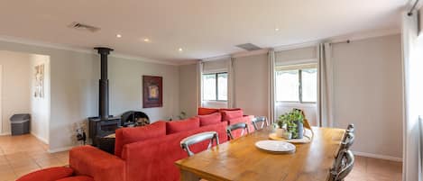 Hunter Gleann Cottage- The living/Dining space with fireplace and TV.