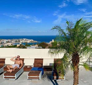Sunny poolside area on the roof with amazing views