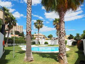 Garden and swimming pools with showers, umbrellas and toilets.