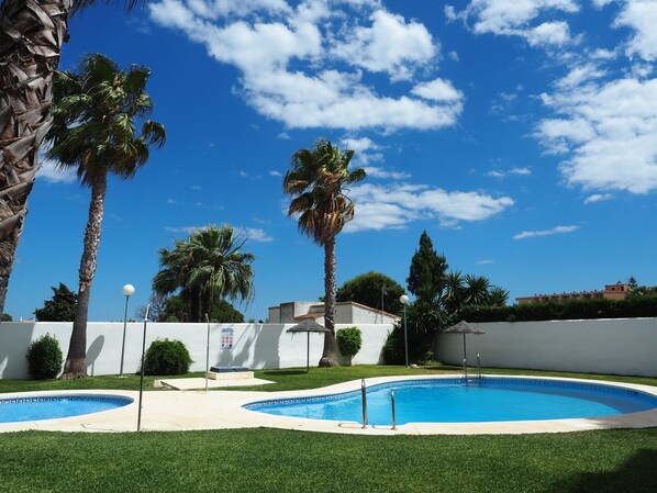 Garden and swimming pools with showers, umbrellas and toilets.