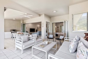 A breezy balcony invites you to come together outside, with picturesque views of Palm Cove Beach. 