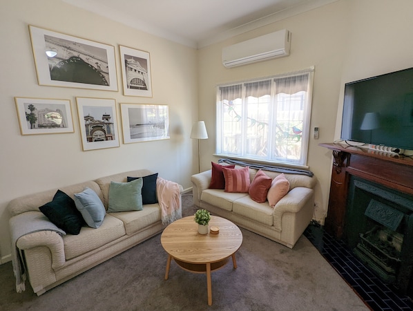 Comfy lounge room with gorgeous light, high ceilings and feature fireplace