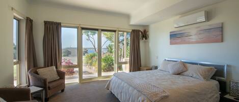 Spacious master bedroom with reading corner and sea views. 