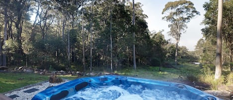 Outdoor spa with bush and valley views