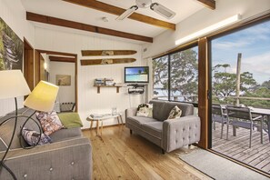 Shabby chic living area connected to outdoor private deck 
