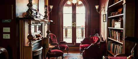 The Upstairs Red Velvet Reading Room leading out onto front Balcony.