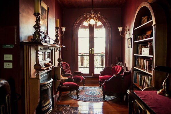 The Upstairs Red Velvet Reading Room leading out onto front Balcony.