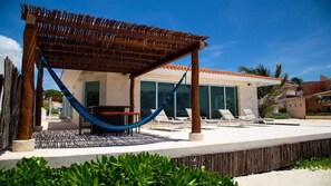 View from the beach to Pool deck, pool bar & Trellis with Hamaca