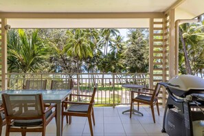 A private balcony off the living area boasts elevated views of Palm Cove's esplanade and the sparkling ocean.