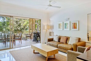 Sliding doors in the living area drench the space in natural light and reveal sparkling, beachfront views.