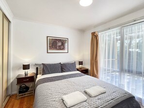 Chic comfort: Bedroom 2 featuring a luxurious queen bed. Your serene retreat.