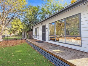 Luminous charm: Sun-drenched cottage radiates warmth and tranquility. 