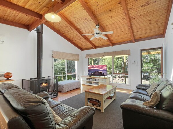 Relax in style: Spacious lounge, wood fire, and smart TV. Perfect retreat.