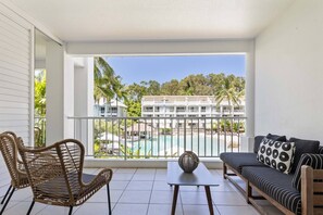 The private balcony overlooks the resort's stunning pool.