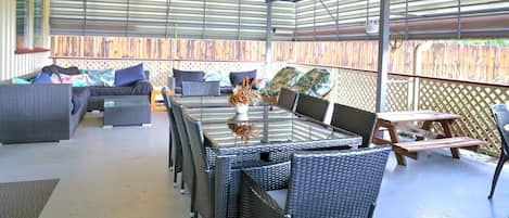 Spacious outdoor dining under two ceiling fans.