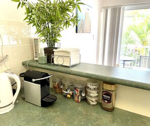 Nespresso coffee pod machine and a starter pack of assorted teas, instant coffee