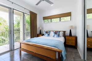 The second bedroom offers direct access to the balcony, bringing the outdoors inside.
